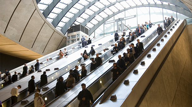 Commuters using escalator getting to subway
